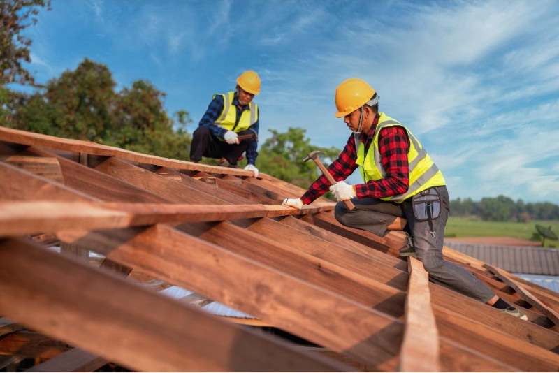 contractor repairing roof